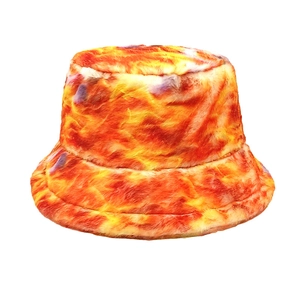 Detailed view of the soft faux fur texture and vibrant orange tie-dye pattern on the hat