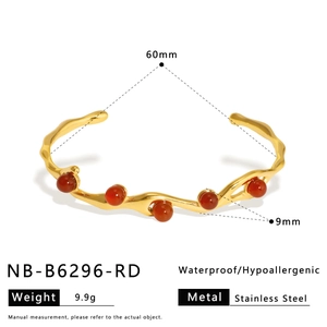 Detail of gold stainless steel bangle with red agate beads showing 60mm diameter and 9mm width