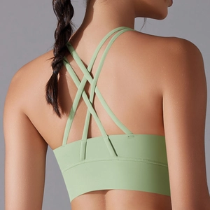 Sage green sports bra with cross-back strap design for high-stretch athletic support