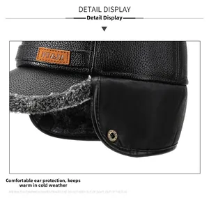Detail view of black faux leather winter hat featuring warm grey faux fur lining and ear flaps