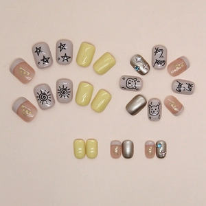 Short glitter press-on nails with cute cat designs, yellow accents, and sparkling rhinestones