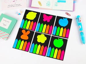 Detail of colorful PET index tabs in leaf, rabbit, and flower shapes on black cards