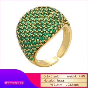 Adjustable gold plated brass ring featuring vibrant round green cubic zirconia stones