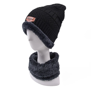 Close-up of black knit hat and neck warmer with thick grey fleece lining for warmth
