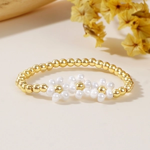Handmade woven daisy beaded ring with three white flowers and golden copper beads