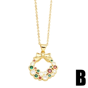 Gold Christmas wreath necklace with red and green cubic zirconia stones on white background