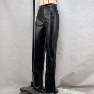 Detail view of high-waist black PU leather pants with front zipper and split hem design
