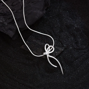 Elegant silver bow pendant necklace on a sleek snake chain with a minimalist design