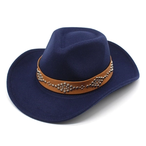 Detail of navy blue felt cowboy hat featuring a brown leather strap and silver metal studs