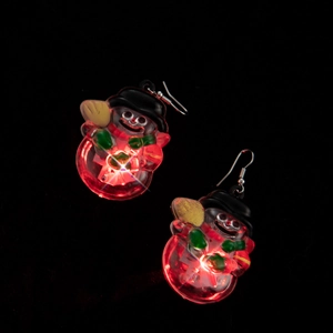 Detail of LED glowing snowman earrings with red lights, black hat and green scarf decor