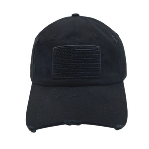 Detailed view of black distressed tactical baseball cap with velcro American flag patch