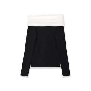 Detailed close-up of ribbed knit texture on black and white off-shoulder sweater
