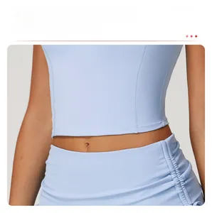 Detail of sky blue sports vest featuring extended hem and ruching texture on fitness wear