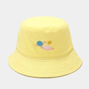 Close-up of yellow cotton bucket hat with detailed blue and pink planet embroidery