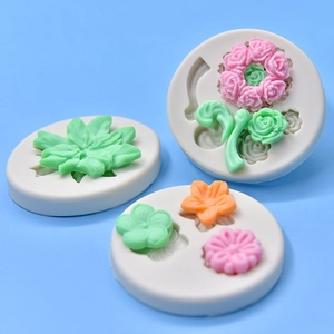 Set of 3 silicone flower and leaf molds for DIY fondant and clay crafts on blue background