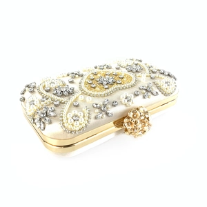Detail of champagne evening clutch featuring floral pearl embroidery and crystal rhinestones