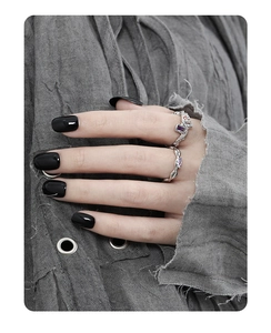 Detail view of s925 silver chain rings with purple and red zircon on hand
