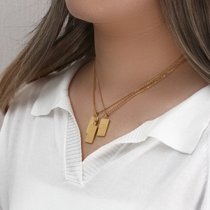 Detail of 18K gold plated multi-layer necklace featuring engraved rectangular pendants