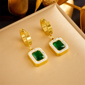 Detail of elegant gold earrings featuring emerald-green square zircon and tiny diamonds