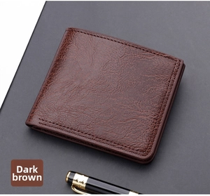 Detailed view of dark brown bifold wallet with pebbled leather texture and pen