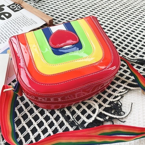 Close-up of rainbow heart crossbody bag with glossy finish and colorful woven strap