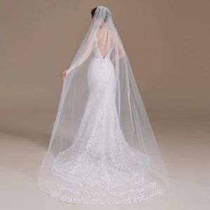 Elegant mermaid bridal gown with V-neck lace bodice and a long cathedral floral lace veil