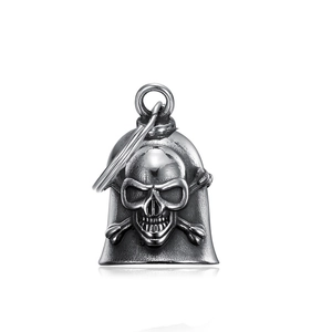 Detailed close-up of a vintage silver skull and crossbones bell pendant with ring