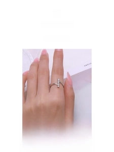 Detail view of a hand wearing the minimalist S925 silver ring with 5 inlaid zircons