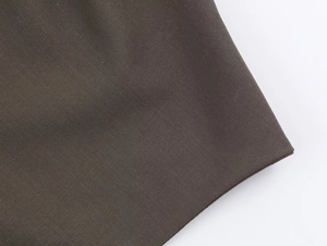 Close-up of high-quality dark charcoal twill blend fabric on women's blazer set