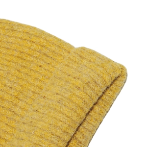 Close-up detail of yellow wool blend knit beanie with sparkling gold sequins and ribbed texture