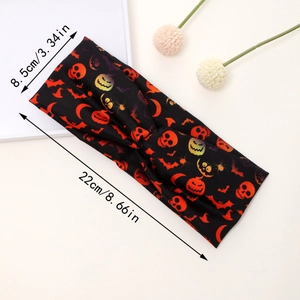 Detail shot of Halloween wide headband with skull, pumpkin patterns and cross knot detail