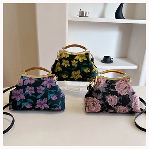 Three vintage floral embroidery qipao handbags with bamboo handles and elegant metal frames