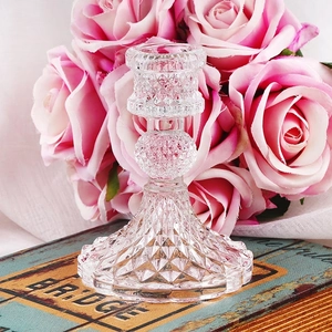 Vintage crystal glass candle holder with diamond texture on retro books with roses
