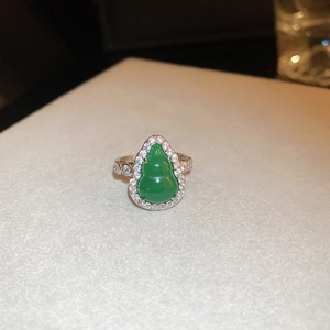 Detailed view of silver open ring featuring a green gourd-shaped stone with pavé zircon