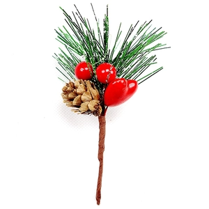 Detail of festive artificial pine branch with red berries and natural pine cone decoration