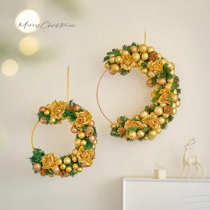 Golden crescent Christmas wreath with pine needles and roses for wall decoration