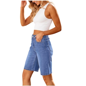 Side view of women's high-waisted blue denim Bermuda shorts with cuffed hem detail