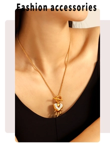 Close-up of gold heart pendant necklace with rhinestones and OT toggle clasp on model