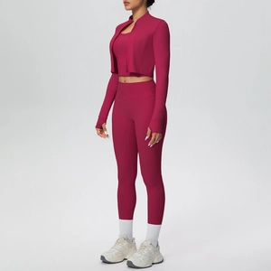 Close-up of pink 3-piece yoga set featuring hooded jacket with thumbholes and leggings