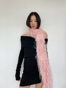 Close-up of pink long faux mink fur scarf on model with black off-shoulder dress