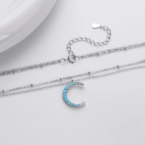Detailed macro view of S925 sterling silver crescent moon necklace with turquoise stone