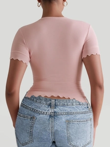 Pink yoga t-shirt featuring stylish wavy hem and sleeve edges for a slim fit look