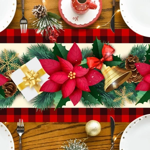 Christmas table runner with gingerbread and poinsettia patterns on a wooden dining table