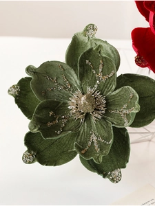 Close-up of olive green velvet artificial flower with golden glitter and bead accents