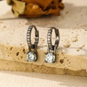 Vintage s925 silver moissanite hoop earrings with round pendants on a beige stone base