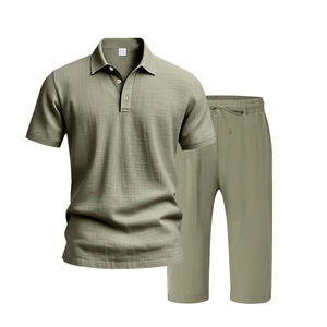 Detail of sage green men's linen polo shirt and drawstring pants set showing fabric texture