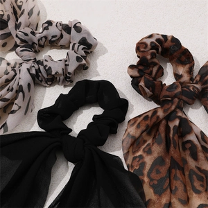 Detail of leopard print and black chiffon scrunchies with elegant bow ties