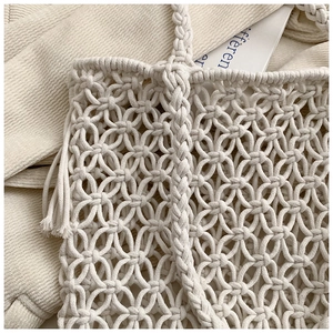 Detailed close-up of handmade cream macramé woven bag featuring intricate knot patterns