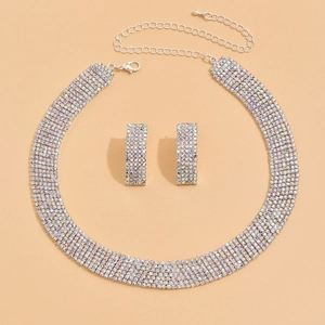Bridal jewelry set with sparkling rhinestones necklace and earrings on beige background