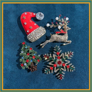 Detailed set of 4 Christmas brooches featuring reindeer, tree, hat and snowflake designs